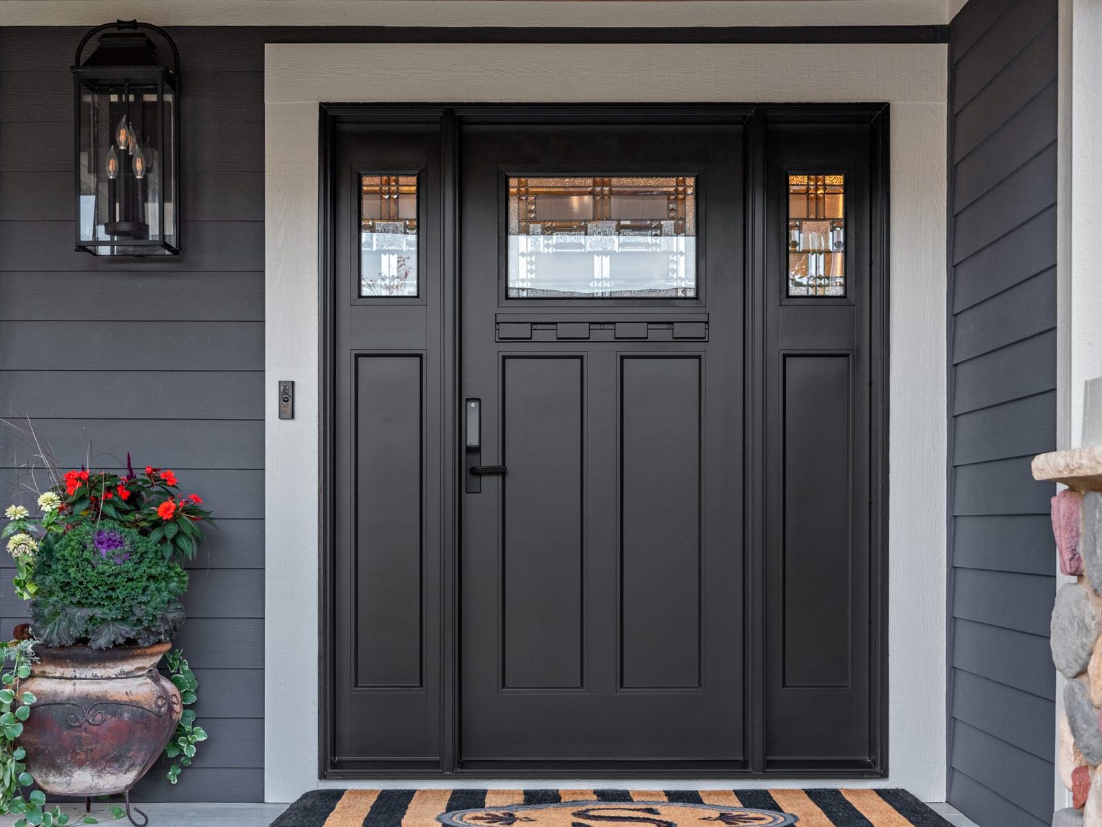 Craftsman-style impact-rated entry door with sidelights on a Fort Myers home