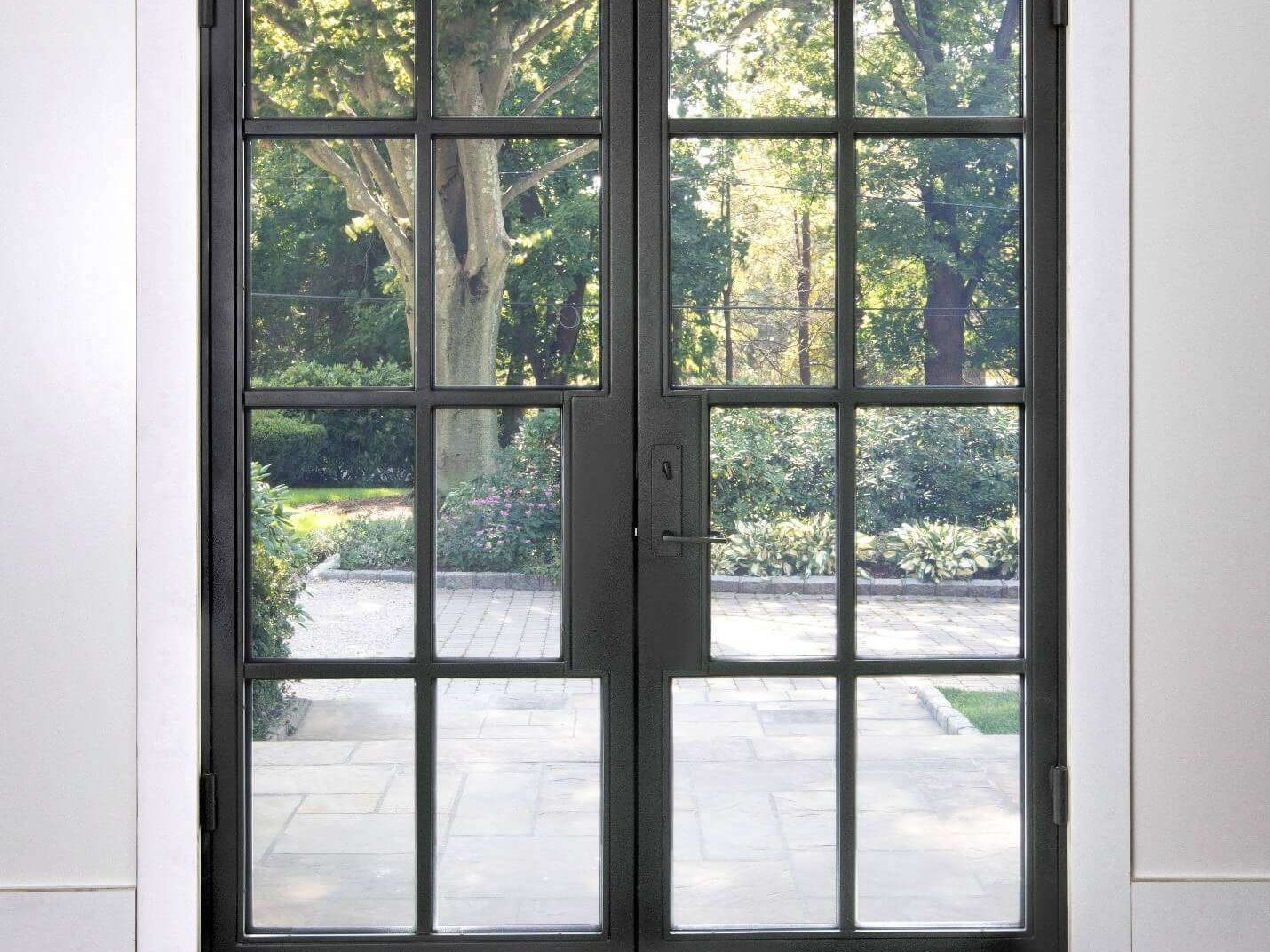 Divided-lite impact French doors opening to a Fort Myers backyard