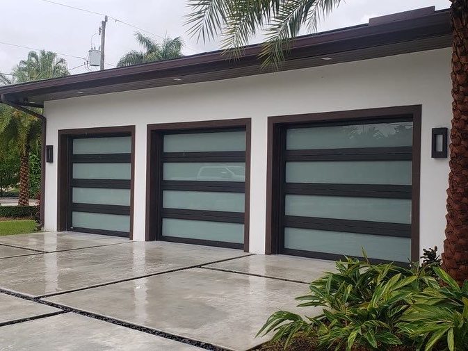 Impact-rated glass-panel garage doors installed on a Fort Myers home